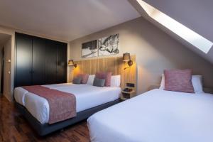 two beds in a hotel room with two beds at Hotel Grand Pas by Nexta in Pas de la Casa +42 photos