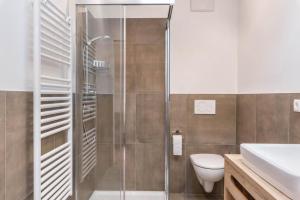 a bathroom with a shower and a toilet and a sink at Balbeinhof Apt Reh in Luson +28 photos