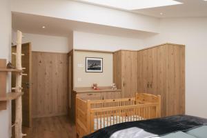 a bedroom with wood paneled walls and a bed at Balbeinhof Apt Reh in Luson