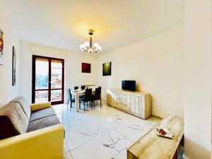 a living room with a couch and a table at - The White Marble Beach Housefree in Marina di Carrara