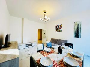 a dining room with a table and chairs at - The White Marble Beach Housefree in Marina di Carrara