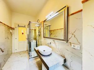 a bathroom with a sink and a mirror at - The White Marble Beach Housefree in Marina di Carrara