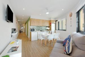 a living room and kitchen with a couch and a table at O Marinheiro 15B in Machico +28 photos