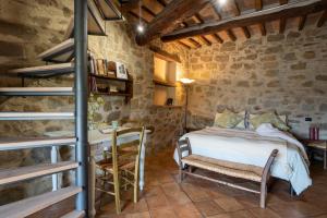 a bedroom with a bed and a table and chairs at Camera con Vista in Anghiari