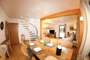 a dining room with a table and a spiral staircase at Ferienhaus Da Vinci in Kirchheim