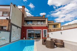 an apartment with a swimming pool in a building at Tranquility Villa with Pool Private Garden & BBQ by PikHost in Tirana