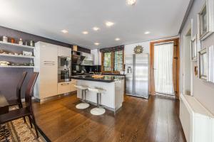 a kitchen with a counter and a refrigerator at Tranquility Villa with Pool Private Garden & BBQ by PikHost in Tirana