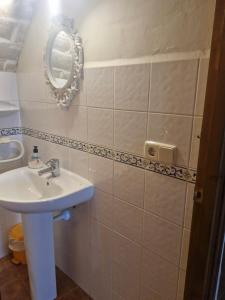 a bathroom with a sink and a mirror on the wall at Mas Pareta - La Parra in Fonolleras +16 photos