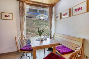 a dining room with a table and chairs and a window at Wohnung Claudia mit Balkon in Todtnau