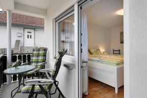 a small room with a bed and a table and chairs at Haus am Buck in Müllheim