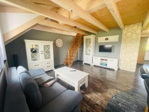a living room with a couch and a table at Ferienwohnung Allgäunest in Argenbühl
