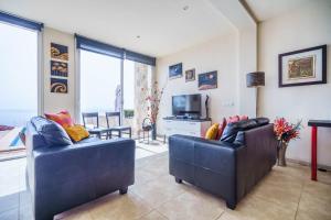 a living room with two couches and a television at Mediterranean Vacation in Mallorca in Cala Pi