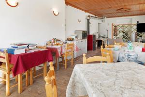 a kitchen and dining room with tables and chairs at B&B San Giovanni in Teglio
