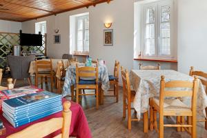 a dining room with tables and chairs and a tv at B&B San Giovanni in Teglio