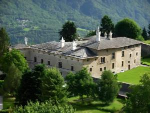 an old castle in the mountains with trees at B&B San Giovanni in Teglio