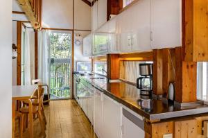 a kitchen with white cabinets and a counter top at Adlerhorst über dem Bodensee in Sipplingen +32 photos
