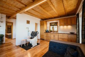 a kitchen with wooden cabinets and a couch in a room at Apartment Judith - Gallhof in Vollan +34 photos