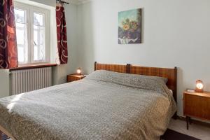 a bedroom with a bed and a window and two lamps at B&B San Giovanni in Teglio