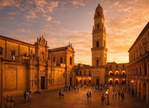 a group of people walking around a building with a clock tower at Quintessenza – Boutique Rooms in Leverano