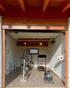 a gym with several exercise equipment in a room at Alpi Liguri - Villa Giulia in Peveragno