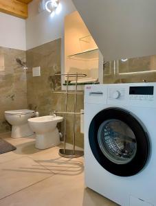 a bathroom with a washing machine and a toilet at Alpi Liguri - Villa Giulia in Peveragno +31 photos