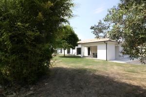 a white house with a yard in front of it at Gîte Basmatho in Yvrac