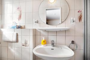 a bathroom with a sink and a mirror at Ferienwohnung 3 in Bernkastel-Kues +4 photos