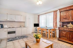 a kitchen with white cabinets and a table and chairs at Ferienwohnung 3 in Bernkastel-Kues