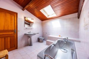 a bathroom with a tub and a toilet and a sink at La Maison de Piquereau in Sauveterre-de-Guyenne +23 photos