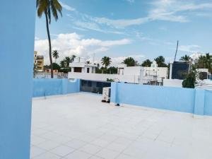 a blue fence on top of a roof at CloudGuestHouse in Kottakupam