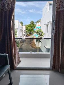 an open window with a view of a street at CloudGuestHouse in Kottakupam +10 photos