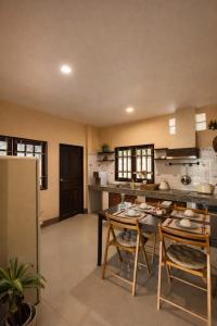 a kitchen with a table and chairs in a room at Lilo House, Thaimueang Beach in Thai Muang