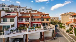an apartment building with a balcony on a city street at Tranquility Villa with Pool Private Garden & BBQ by PikHost in Tirana