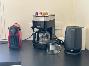 a coffee maker sitting on top of a counter at La douce Escale maison 2 chambres à 50 m de la plage in Royan +10 photos