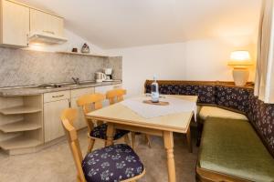 a small kitchen with a table and chairs in a room at Hotel Liberia in Oberstdorf
