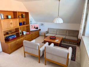 a living room with a couch and a table at Südblick 1 in Fehmarn