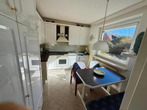 a small kitchen with a small table and a small table at Südblick 1 in Fehmarn