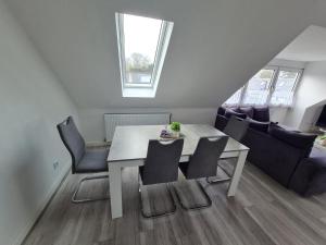a dining table and chairs in a living room at Ferienwohnung Inselblick Vitzdorf in Fehmarn +2 photos