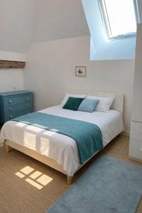 a bedroom with a large bed and a window at Cadre d'exception et nature - 2 Maisons - 15 pers max in Aigné