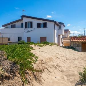 a house sitting on top of a sandy beach at Fiorucci Apartments - Marco's House in Focene