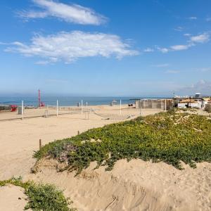 a sandy beach with a volley ball net at Fiorucci Apartments - Marco's House in Focene +9 photos