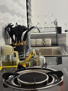 a kitchen counter with a stove with plates and utensils at Two bedrooms apartment in Moshi town in Moshi