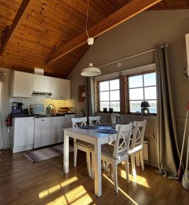 a kitchen and dining room with a table and chairs at Ulvsby Ranch Western Camp in Karlstad