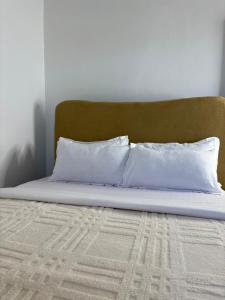 a bed with two white pillows on top of it at Two bedrooms apartment in Moshi town in Moshi