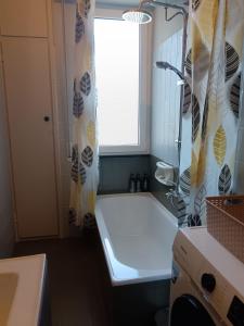 a bathroom with a tub and a shower curtain at Ilgattonero in Orero +29 photos