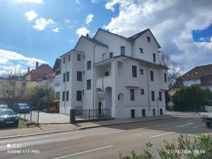 a white building on the side of a street at City Apartments Göppingen in Göppingen