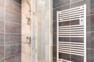 a shower with a glass door in a bathroom at Chalet Les Lys - Tout Confort in Valloire