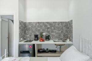 a small kitchen with a sink in a room at Politimis Studio N3 in Amorgos
