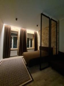 a bedroom with a mirror and a bed and window at Апартаменти Центр in Lutsk