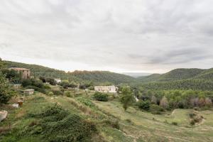 a view of a valley with a house in the distance at Casa refugi les Orenetes in Rocafort